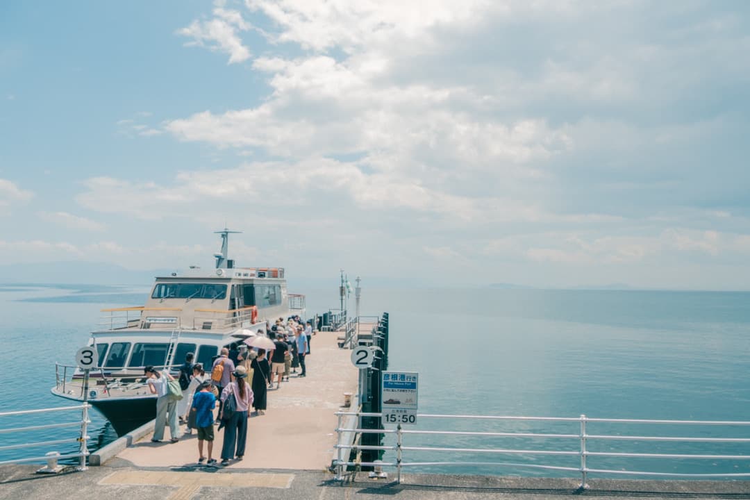 Travelers boarding a boat at the harbor